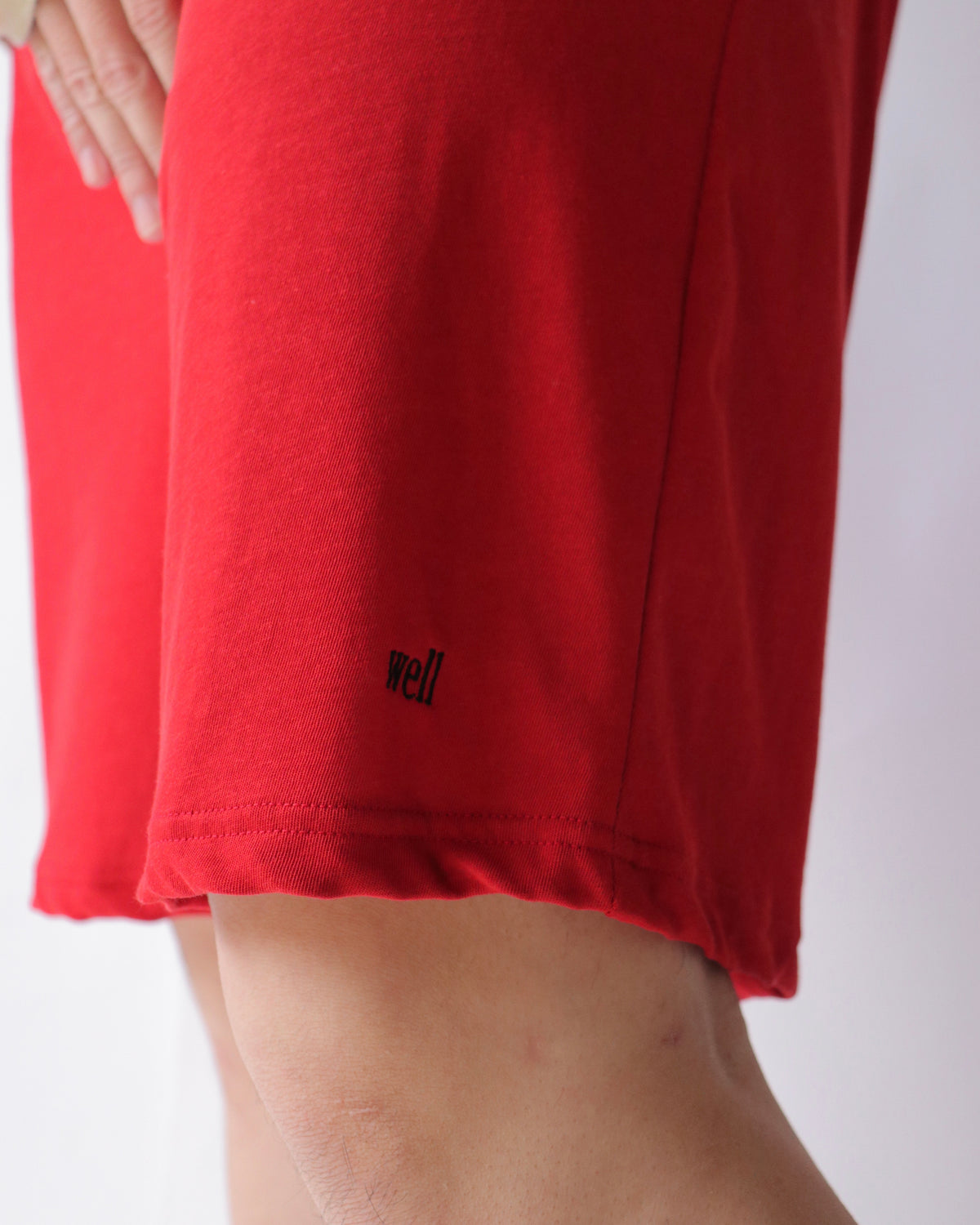well / title logo shorts red